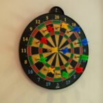 a dartboard on the wall with colorful darts