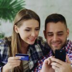 couple online shopping with credit card and smartphone