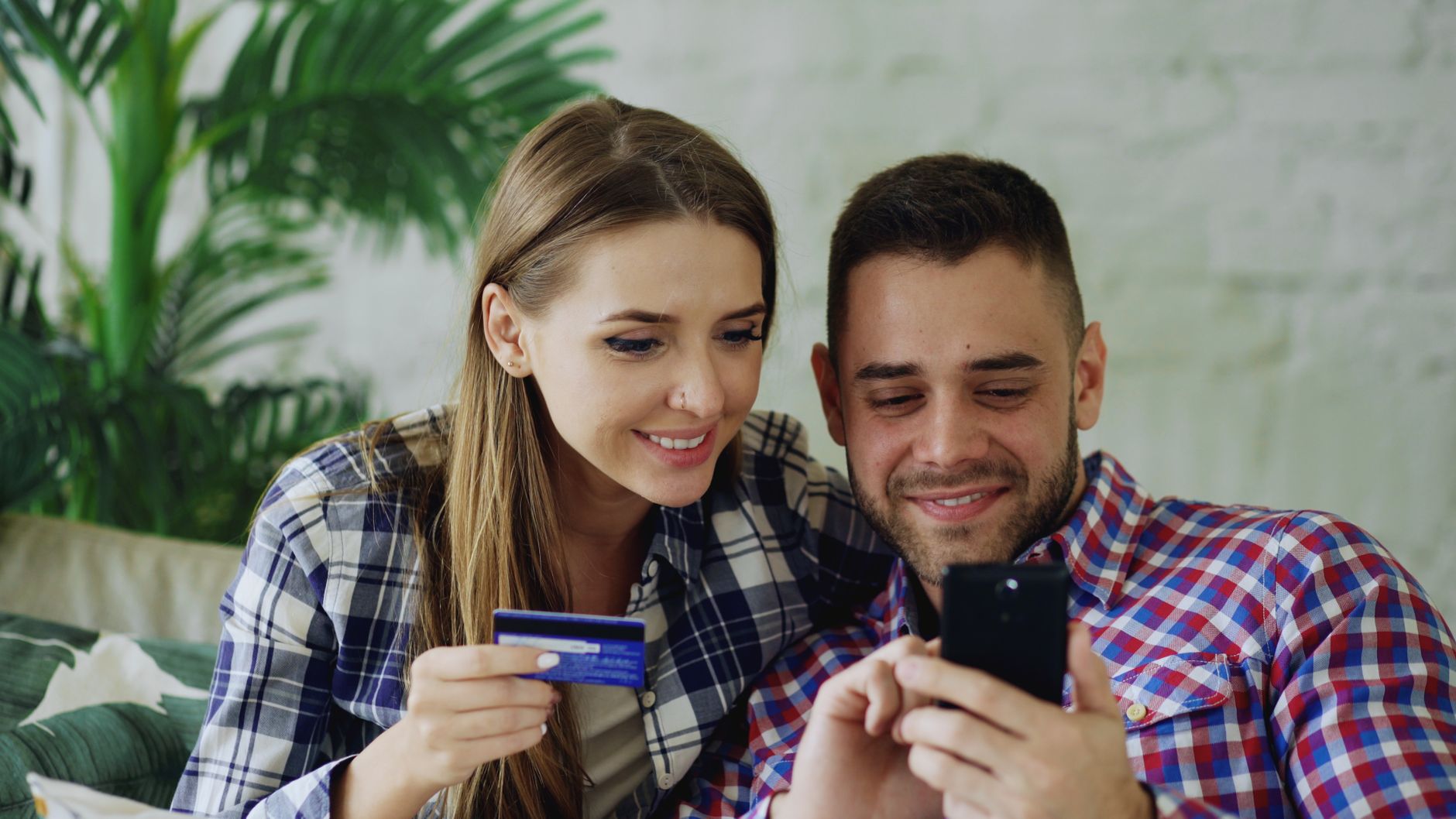 couple online shopping with credit card and smartphone